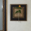 壁掛け仏壇「鏡壇ミラリエ」に今日（3/4）の誕生花の「八重咲のヤマブキ（山吹）」を飾ってみました。